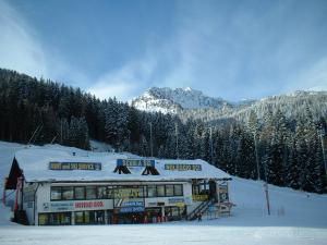 ein schneebedecktes Gebäude auf einer Skipiste in der Unterkunft Appartamento Artuik in Marilleva