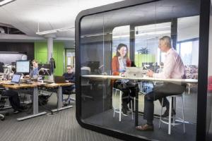 a group of people sitting at tables in an office at A-Capital Hill Hideaway in Seattle