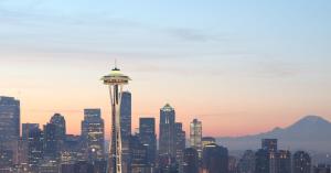 a city skyline with a space needle in the foreground at Seattle Urban Village- San Juan- Roof top view deck in Seattle