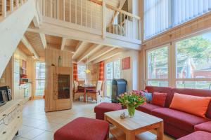 a living room with a red couch and a table at Ferienhaus Seepferdchen in Baabe