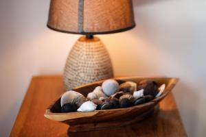 a bowl of shells on a table next to a lamp at North Beach Retreat in San Pedro