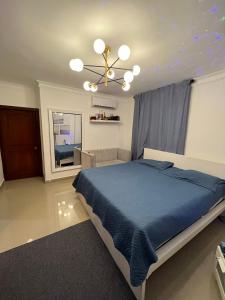 a bedroom with a blue bed and a ceiling at Lagrande Home in La Grúa