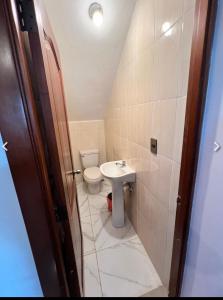 a small bathroom with a toilet and a sink at Lagrande Home in La Grúa