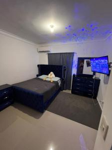 um quarto com uma cama, uma cómoda e uma televisão em Lagrande Home em La Grúa