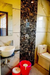 a bathroom with a sink and a toilet at HOTEL SAMRUDDHI in Panchgani