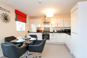 a kitchen and dining room with a table and chairs at Fabulous Aberdeen Home near the city centre in Dyce