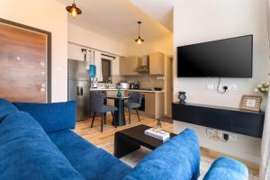 a living room with a blue couch and a kitchen at Westlands blue Condo with Pool&Gym in Nairobi