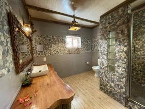 a bathroom with a sink and a toilet at Anse Severe Beach Villas in La Digue