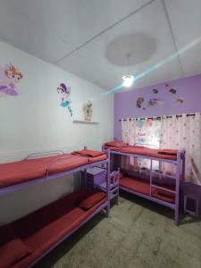 two bunk beds in a room with purple walls at Ward80 Wayanad in Vythiri