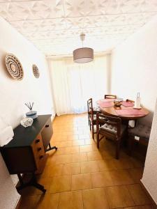 a dining room with a table and a table and chairs at Apartament Central Castellon! in Castellón de la Plana