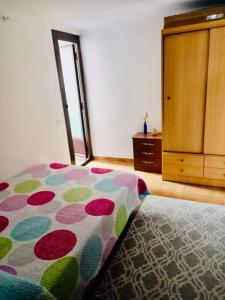 a bedroom with a bed and a dresser in a room at Apartament Central Castellon! in Castellón de la Plana
