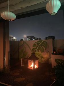 a fire pit on a patio at night at Bedradio Dodubong in Jeju