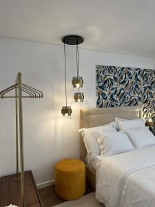 a bedroom with a bed with a table and a stool at Quinta de Gandarem in Torre de Moncorvo +13 photos
