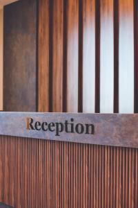a sign that says reception on a wooden fence at The Yalı Konak Hotel İzmir in İzmir