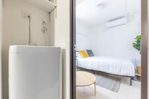 Postel nebo postele na pokoji v ubytování APB高円寺