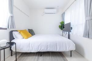 Postel nebo postele na pokoji v ubytování APB高円寺