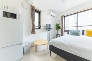 Postel nebo postele na pokoji v ubytování APB高円寺