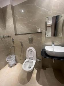 a bathroom with a white toilet and a sink at HOTEL IVORY INN NEW DELHI At IGI AIRPORT in New Delhi