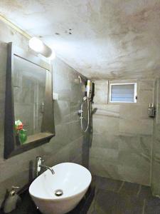 a bathroom with a sink and a mirror at Vang Vieng Garden Villa in Vang Vieng