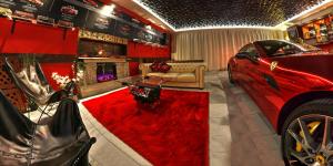 a living room with a red car and a fireplace at Ferrari wellness apartmán in Pardubice