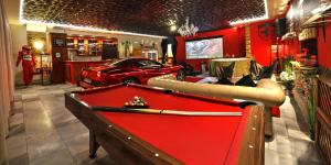 a red pool table in a room with a car at Ferrari wellness apartmán in Pardubice