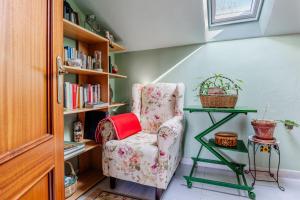 ein Zimmer mit einem Stuhl und einem Bücherregal in der Unterkunft Casa Montañesa in El Astillero