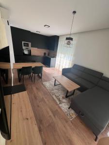 a living room with a couch and a table at Luxury Apartment Posusje in Posušje +12 photos