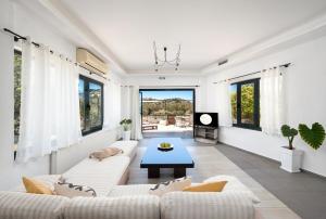 a living room with a couch and a table at Coastal Dream beachView Jacuzzi& sauna free parking WiFi 2 bedroom in Amoudara Lasithiou