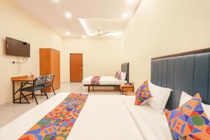 a hotel room with a bed and a tv at FabHotel Mint Park in Hyderabad