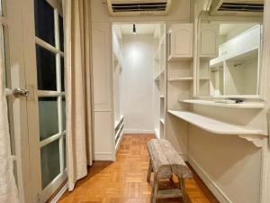 a hallway with white cabinets and a bench in a room at Sabaiday Guesthouse Nimman in Chiang Mai +241 photos