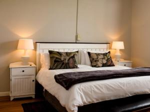 a bedroom with a large bed with two night stands at Sewefontein Guest Farm in Citrusdal