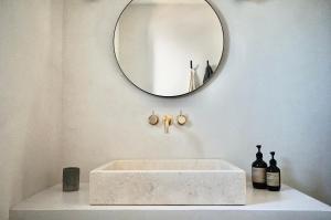 a bathroom with a white sink and a mirror at Soul Valley all-in boutique hotel with yoga & wellness in Torre delle Stelle