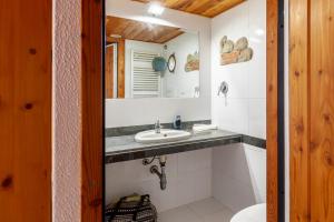 a bathroom with a sink and a mirror at Loft in centro a Torre del Lago in Torre del Lago Puccini