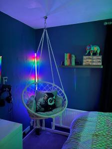 a room with a swing in a bedroom with blue walls at Modern family home central Cheltenham in Cheltenham