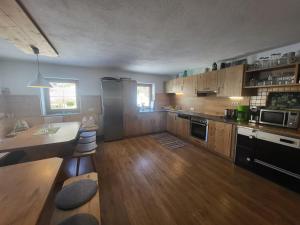 a large kitchen with wooden cabinets and a counter top at Ferienhaus Unterbrunnhaus in Finkenberg