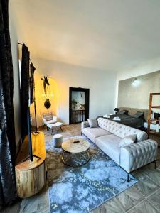 a living room with a couch and a table at Opera apartments - Mestský palác in Banská Štiavnica