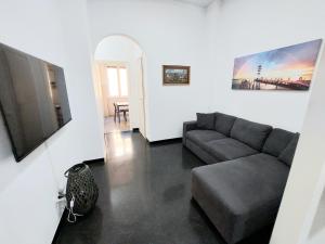 a living room with a couch and a television at Home Cristina in Genova