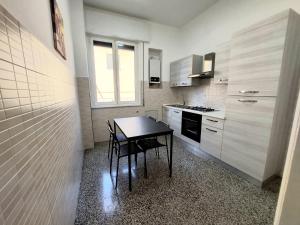 a small kitchen with a table and a stove at Home Cristina in Genova