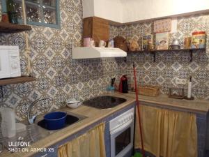 a small kitchen with a sink and a stove at Casa Rural El Callejón in Albalate de Zorita +8 photos