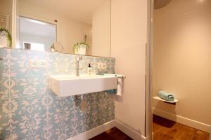 a bathroom with a sink and a mirror at Haus Anna - Wohnung 3 in Wangerooge