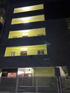 a building with yellow and black stripes on it at Y STAY HOMESTAY in Tirupati