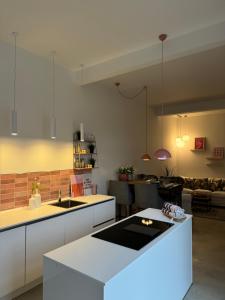 a kitchen with a white island in a room at Sievershof Strandbar in Wietzendorf
