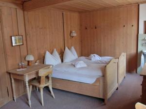 1 Schlafzimmer mit einem Bett und einem Schreibtisch mit einem Bett von sidx sidx sidx in der Unterkunft Hotel Rhätia in Luzein