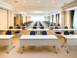 an empty classroom with tables and chairs at Chisun Hotel Hiroshima in Hiroshima