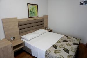 a bedroom with a bed with a wooden headboard at Mandalin Otel in Antalya