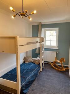 a bedroom with a bunk bed with a blue mattress at Lot54 Deluxe Apartements in Neidenbach