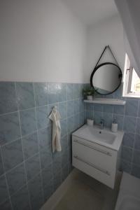 a bathroom with a sink and a mirror at Cinege Vendégház Szekszárd in Szekszárd