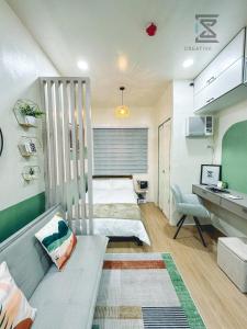 a room with a couch and a bed and a desk at CreativeSpace-Mactan2 in Lapu Lapu City