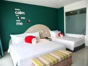 1 dormitorio con 2 camas con animales de peluche en SLEEP WITH ME HOTEL design hotel @ patong (SHA Plus+), en Patong Beach