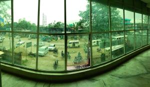 a view of a parking lot through a window at Hotel Yuvraj Palace in Chutiyā Mīrigaon